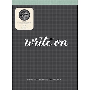 May include: A black grid pad with the words "write on" in white script. The pad has a light green border at the top and a cream-coloured square with the "Kelly Creates" logo and text. The pad contains 50 pages.