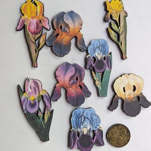 May include: A set of three ceramic mugs with a speckled, matte finish. The mugs are in shades of cream, light gray, and dark gray. Each mug has a simple, minimalist design and a rounded handle. The mugs are stacked on top of each other.