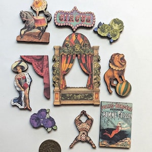 May include: A collection of vintage-style circus-themed wooden cutouts. Includes a horse and rider, a circus sign, a stage, a roaring lion, a performer, and a vintage poster with the text "HOMME POISSON".