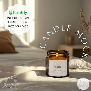 May include: A brown glass candle jar with a white label that reads "lavender & vanilla soy wax candle". The candle is sitting on a white bedspread with a text overlay that reads "candle mockup".