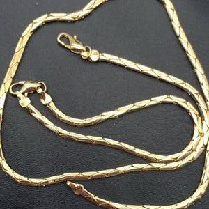 Vintage glanzende goudkleurige set mariner- of ankerketting en armbanden