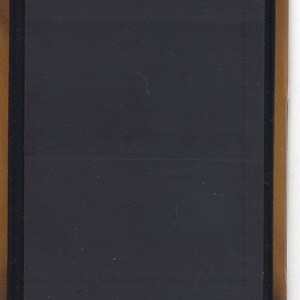May include: A black framed rectangular magnet with a blank surface.