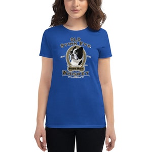 May include: A royal blue women's t-shirt with a vintage-style illustration of a Boston Terrier dog. The illustration is surrounded by a gold oval with the text "Old Stink Eye Pure Rye Whiskey" in a brown font.