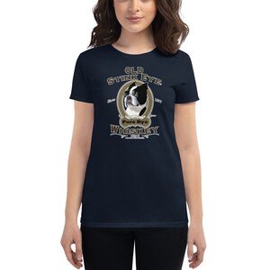 May include: A navy blue women's t-shirt with a graphic of a Boston Terrier dog with the text "Old Stink Eye Pure Rye Whiskey" in a gold and brown vintage style.