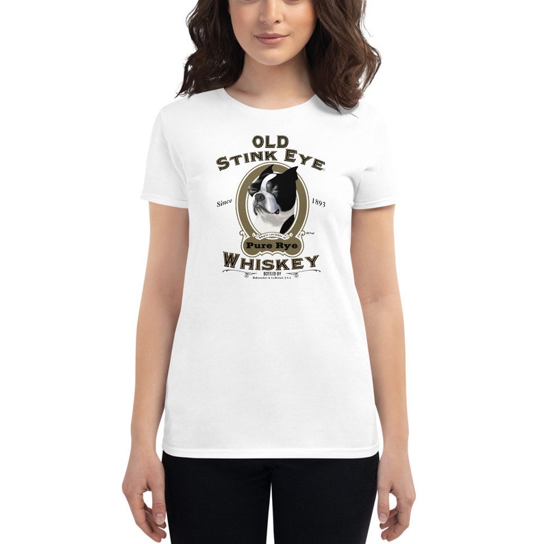 May include: White t-shirt with a brown and gold graphic of a Boston Terrier dog with the text "Old Stink Eye Pure Rye Whiskey" and the years "Since 1893" and "1893".