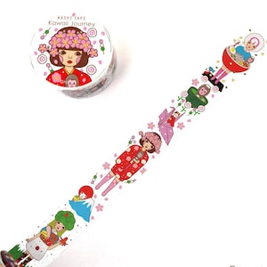 May include: A roll of washi tape with a pink and white design featuring a Japanese woman in a red kimono with a monkey on her shoulder. The tape also features a pink origami crane, a mountain, and a woman in a red bowl. The text "Washi Tape Kawaii Journey" is printed on the roll.