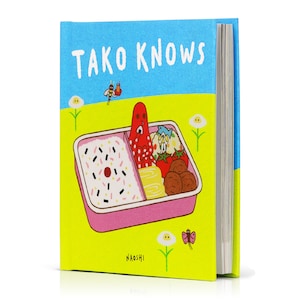 May include: A colourful children's book titled "Tako Knows" with an illustration of a pink lunchbox filled with food. The lunchbox has a red octopus, a fish, and a cherry on top.