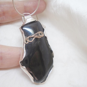 Whitby Jet in a sterling silver handmade surround, B quality, broken stone. Hallmarked silver and Whitby Jet pendant