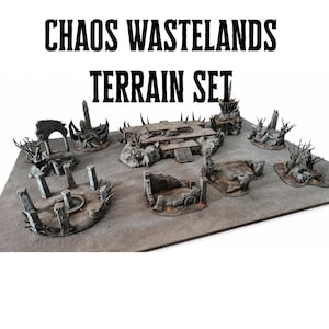 May include: A tabletop terrain set with the text "CHAOS WASTELANDS TERRAIN SET". The set features miniature structures, including ruins, pillars, and a multi-level building, in shades of grey and brown, designed for tabletop gaming.
