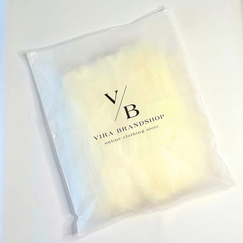 May include: A white plastic mailing bag with a zipper closure. The bag has a black logo that says "Vira Brandshop" and "online clothing store".