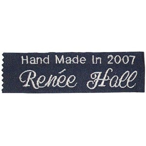 May include: A navy blue fabric label with white embroidery that reads "Hand Made In 2007 Renée Hall".
