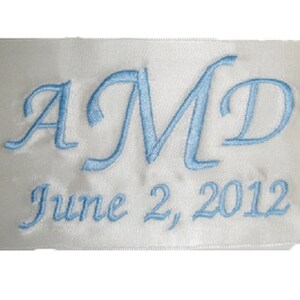 May include: White satin ribbon with blue embroidered letters "AMD" and the date "June 2, 2012".