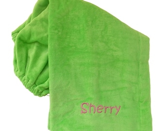 May include: A bright green hooded towel with the name "Sherry" embroidered in pink.