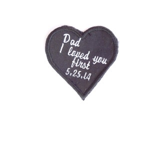 May include: Black heart-shaped patch with white embroidery that reads "Dad I loved you first 5.25.14".