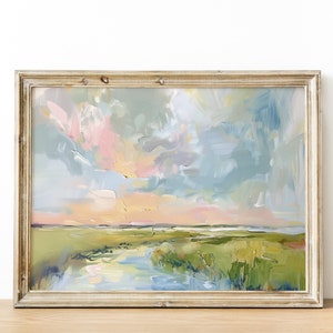 Op de afbeelding: Een abstract landschapsschilderij in een goudkleurige houten lijst. Het kunstwerk toont een levendige lucht met pastelroze, blauwe en gele tinten. De voorgrond toont een groen moeras met een waterpartij, wat een serene en kleurrijke sc&egrave;ne cre&euml;ert.