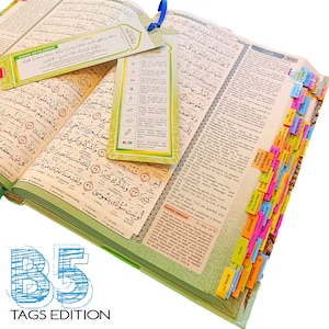 May include: Open Quran with colorful page tabs and bookmarks. The book is open to a page with Arabic script. The bookmarks have text in English and Arabic. The image also includes the text "B5 TAGS EDITION".