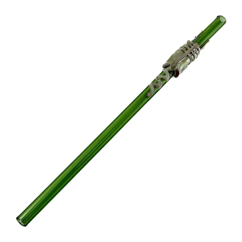 A green glass straw with a metal clasp attached to it.