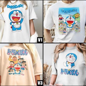 May include: Four white t-shirts featuring the cartoon character Doraemon. The shirts display Doraemon in various poses, with the character's name in English and Japanese. The designs include Doraemon with friends and solo poses. The shirts are short-sleeved.