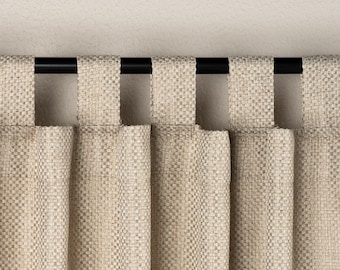 May include: Close-up of beige woven fabric curtains with a black rod. The curtains have a textured appearance and are hanging from the rod with fabric loops. The neutral color and simple design suggest a minimalist style.