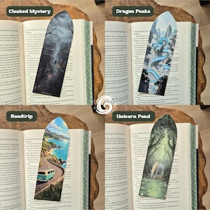 May include: Four bookmarks with pointed tops featuring illustrations titled Cloaked Mystery, Dragon Peaks, Roadtrip, and Unicorn Pond. Each bookmark displays a unique scene: a dark village, a blue dragon in mountains, a coastal road, and a unicorn.