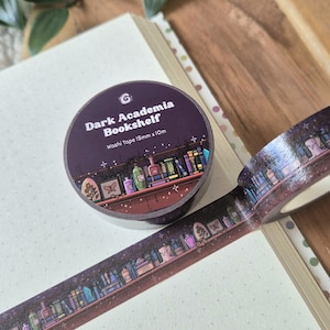 May include: A roll of washi tape with a dark purple background and the text "Dark Academia Bookshelf." The tape features a repeating design of a bookshelf with books, bottles, and decorative items. The tape is 15mm x 10m.