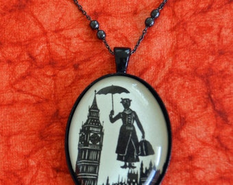 May include: A black chain necklace with a round glass pendant featuring a silhouette of Mary Poppins holding an umbrella in front of Big Ben.