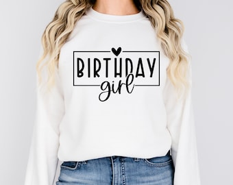 May include: White sweatshirt with black text that says "Birthday girl" with a small heart above the word "Birthday".