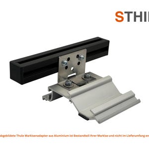 May include: A metal bracket with a black rectangular bar and silver-colored base. The bracket is attached with bolts and nuts. The word "STHIEL" is in orange and gray text in the upper right corner.