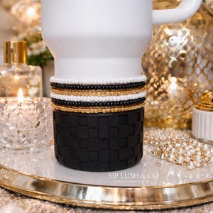 May include: A set of three ceramic mugs with a speckled, matte finish. The mugs are in shades of cream, light gray, and dark gray. Each mug has a simple, minimalist design and a rounded handle.