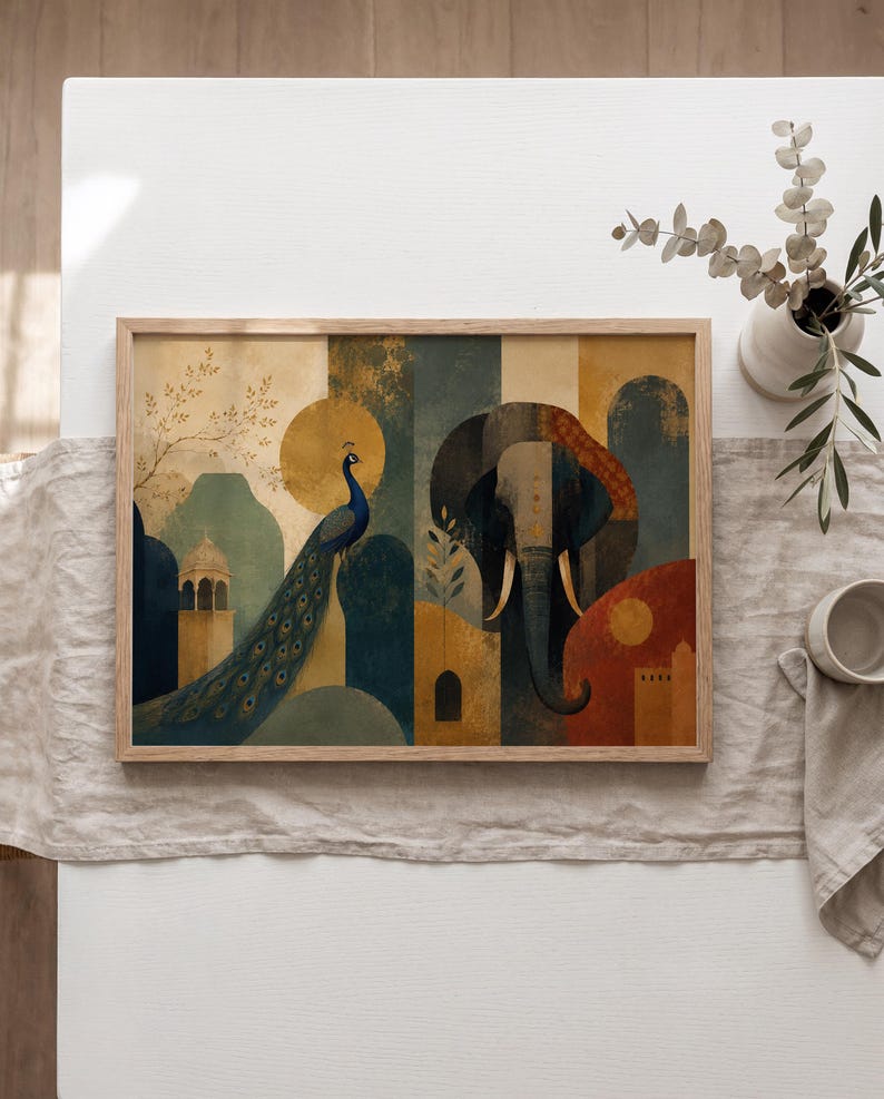 May include: A rectangular framed wall art print featuring a stylized illustration of a peacock and an elephant. The artwork uses a palette of deep blue, mustard yellow, and terracotta red, depicting architectural elements and circular sun motifs.