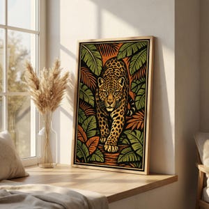 May include: A framed art print featuring a stylized jaguar walking forward. The artwork has a jungle theme, with the jaguar surrounded by green and orange foliage. The jaguar has a spotted coat and is set against a black background.