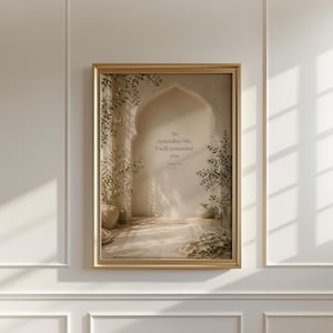 May include: A framed print featuring an arched doorway scene with plants and soft lighting. The text "So remember Me; I will remember you" is displayed in the center. The frame is gold.