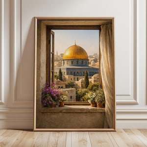 May include: Framed artwork depicting a view through a window. The image shows a golden-domed building, likely a religious site, surrounded by other structures. Potted plants sit on the windowsill. The artwork is framed in a wooden frame.