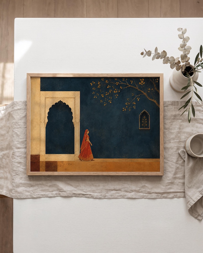 May include: A rectangular framed wall art print featuring a dark blue wall with a golden archway and a small window. A figure in a vibrant orange garment walks along a golden floor. A tree branch with golden leaves extends across the upper right side.