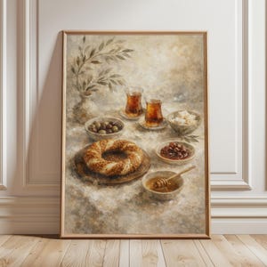 May include: A framed print of a breakfast scene. A sesame seed bagel sits on a wooden plate, surrounded by small bowls of olives, jam, cheese, and honey. Two glasses of tea and a vase with greenery complete the arrangement.