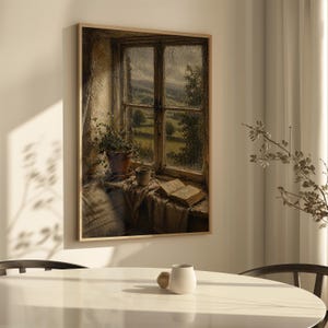 May include: A framed painting depicts a window scene with a view of a green landscape. A potted plant, a cup, and an open book sit on the windowsill. The painting has a warm, inviting color palette with a focus on natural light and shadow.