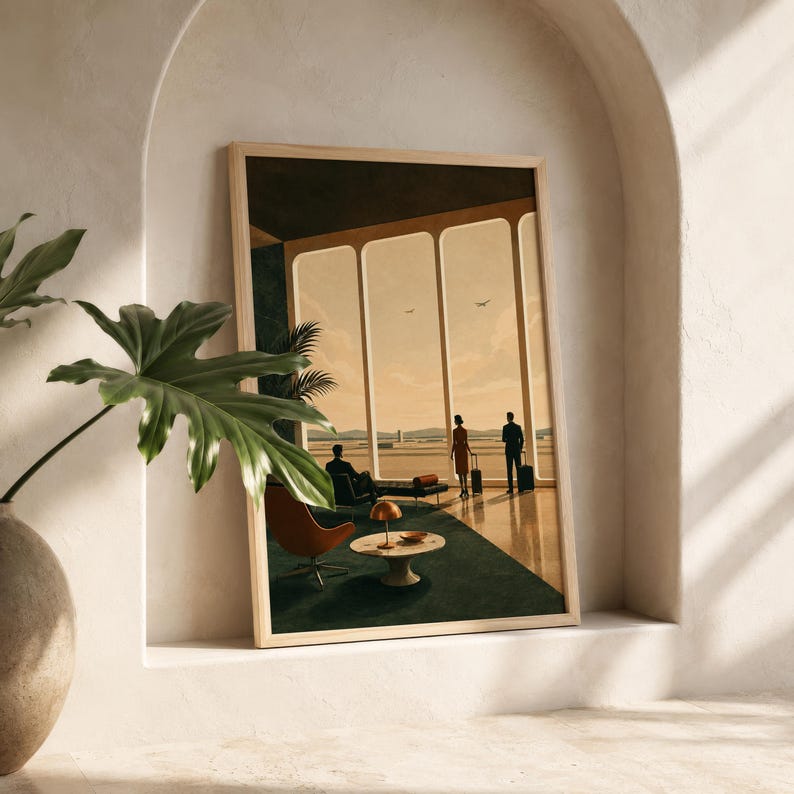 May include: A framed wall art print depicting a mid-century airport lounge with floor-to-ceiling windows, silhouettes of travelers with luggage, a round coffee table, a lamp, and an orange chair, all set against a warm, golden-toned sky.