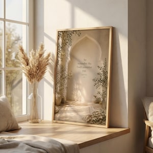 May include: A framed print featuring an arched doorway scene with text that reads, "So remember Me: I will remember you." The print has a light wood frame and is displayed on a wooden ledge near a window. A vase of dried flowers sits nearby.