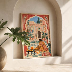May include: A framed rectangular art print featuring a colorful illustration of a person in a yellow garment kneeling on a tiled patio, arranging orange flowers in baskets. The scene includes a fountain, potted plants, and an arched building.