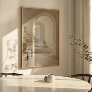 May include: A framed artwork showing an arched hallway leading to an outdoor scene. The painting uses soft, neutral tones, focusing on architectural details and a sense of calm. A vase with a plant is visible.