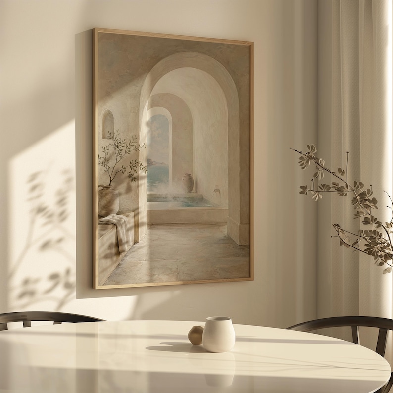 May include: A framed artwork showing an arched hallway leading to an outdoor scene. The painting uses soft, neutral tones, focusing on architectural details and a sense of calm. A vase with a plant is visible.