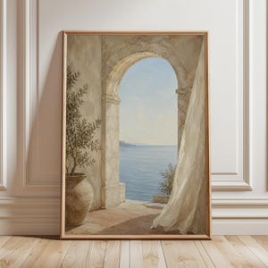 May include: Framed art print depicting an arched doorway overlooking a serene seascape. The artwork features a stone archway, a potted olive tree, and a sheer curtain blowing in the breeze. The color palette includes soft blues, beige, and earth tones.