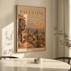 May include: A framed wall art print titled PALESTINE, featuring a warm-toned illustration of a historic city with a golden dome, stone buildings, and flowering vines under a sunset sky. The text reads LAND OF HISTORY, PEOPLE & HERITAGE.