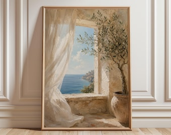 May include: A framed wall art print depicting a Mediterranean scene through an open stone window. A sheer white curtain blows inward, revealing a blue sea and sky. An olive tree in a terracotta pot sits on the stone ledge beside the window.