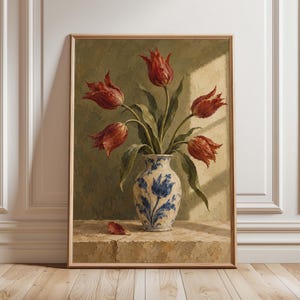 May include: A framed oil painting depicting five deep red tulips in a white ceramic vase with blue floral patterns. The vase sits on a stone surface against a muted olive green wall with a patch of sunlight illuminating the scene.