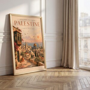 May include: A framed vertical art print featuring a warm-toned illustration of a cityscape with the text PALESTINE, LAND OF HISTORY, PEOPLE & HERITAGE, A LAND OF TIMELESS BEAUTY, and MEDITERRANEAN HERITAGE. The scene depicts stone buildings, a golden dome, and flowers.