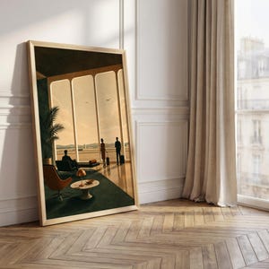 May include: A framed rectangular wall art print depicting an airport lounge scene with large windows, a dark green carpet, a brown lounge chair, a small round table with a lamp, and three figures standing or sitting with luggage in a warm light.