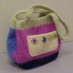 May include: A striped knitted tote bag with a fluffy texture. The bag has a light green handle, a blue, pink, and purple striped body, and a white pocket with a floral design and three flower buttons.