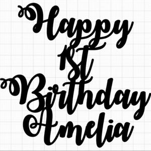 May include: Black cake topper with the words "Happy 1st Birthday Amelia" in a cursive font. Ideal for a first birthday celebration. The design is simple and elegant, suitable for a cake decoration.