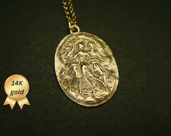 May include: A gold pendant necklace with a detailed oval-shaped charm featuring a sculpted design of three figures. The charm is made of 14k gold.